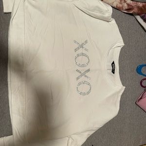 Cute half shirt more of a cream color very cute just never wore it.